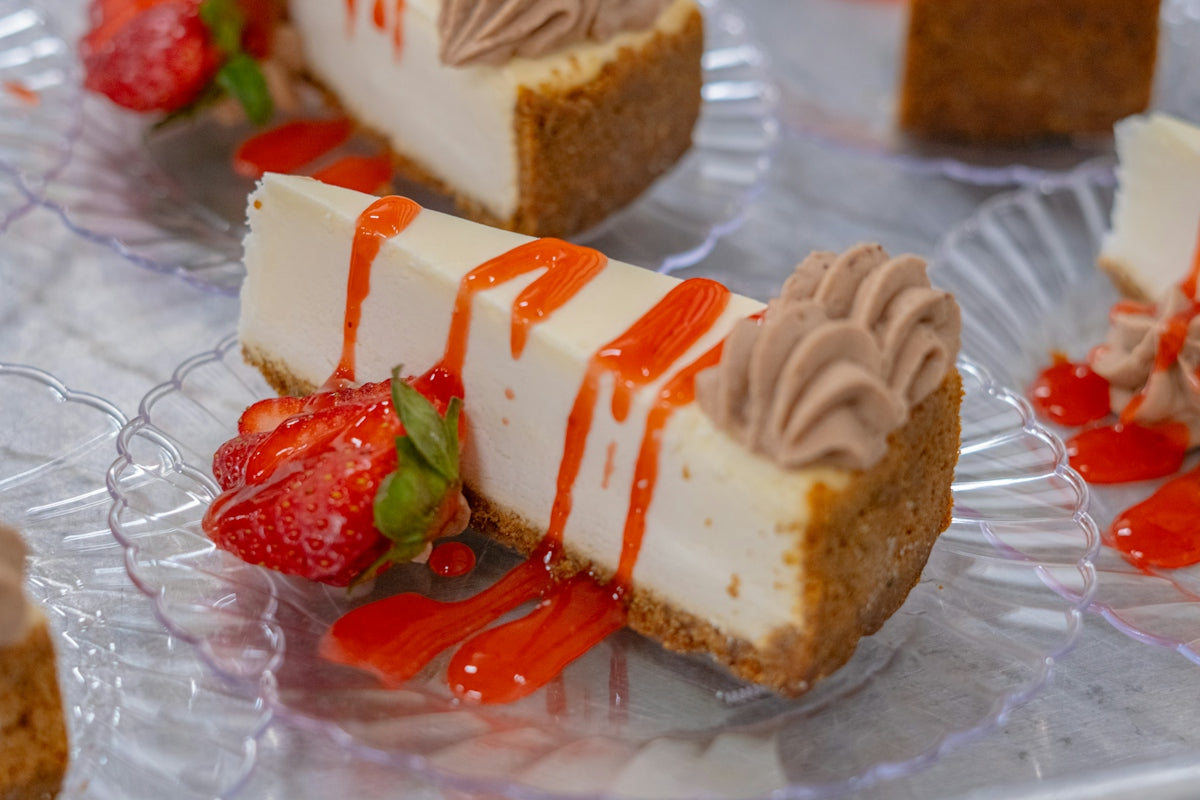 Cheesecake slices with strawberries and sauce